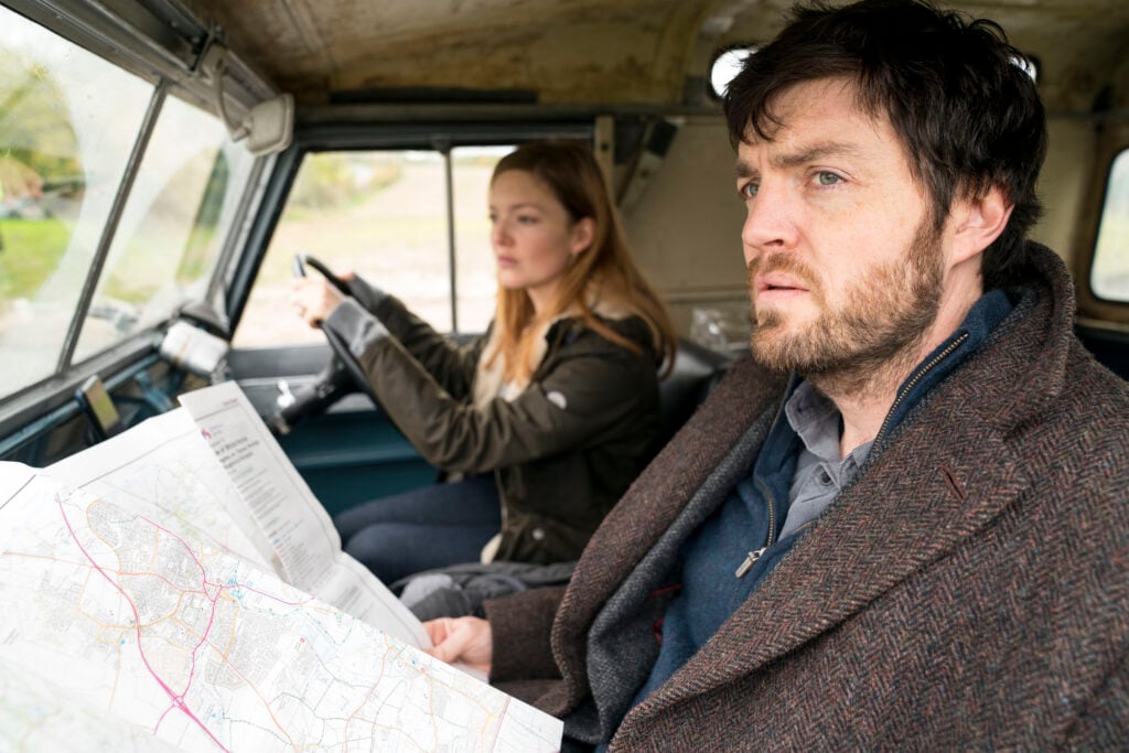 strike and robin in a landrover