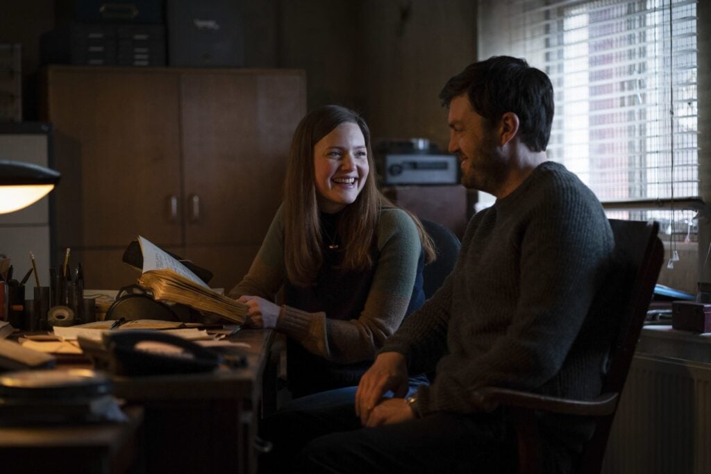 Strike and Robin laughing together in the office