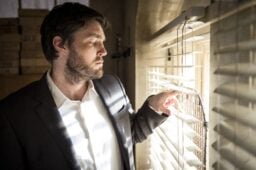 strike in his office looking through blinds