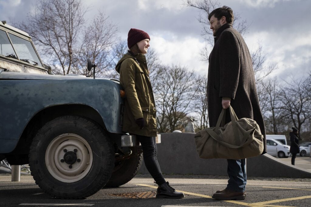 Strike talking to Robin next to their Landrover